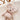 Zoom sur la Peluche Souris en minky beige latte avec son noeud papillon posée dans un berceau