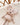 Zoom sur la Peluche Souris en minky beige latte avec son noeud papillon posée dans un berceau