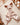 Doudou plat cerf en minky beige et double gaze dans un berceau.