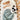 Doudou panda personnalisable niché dans une feuille